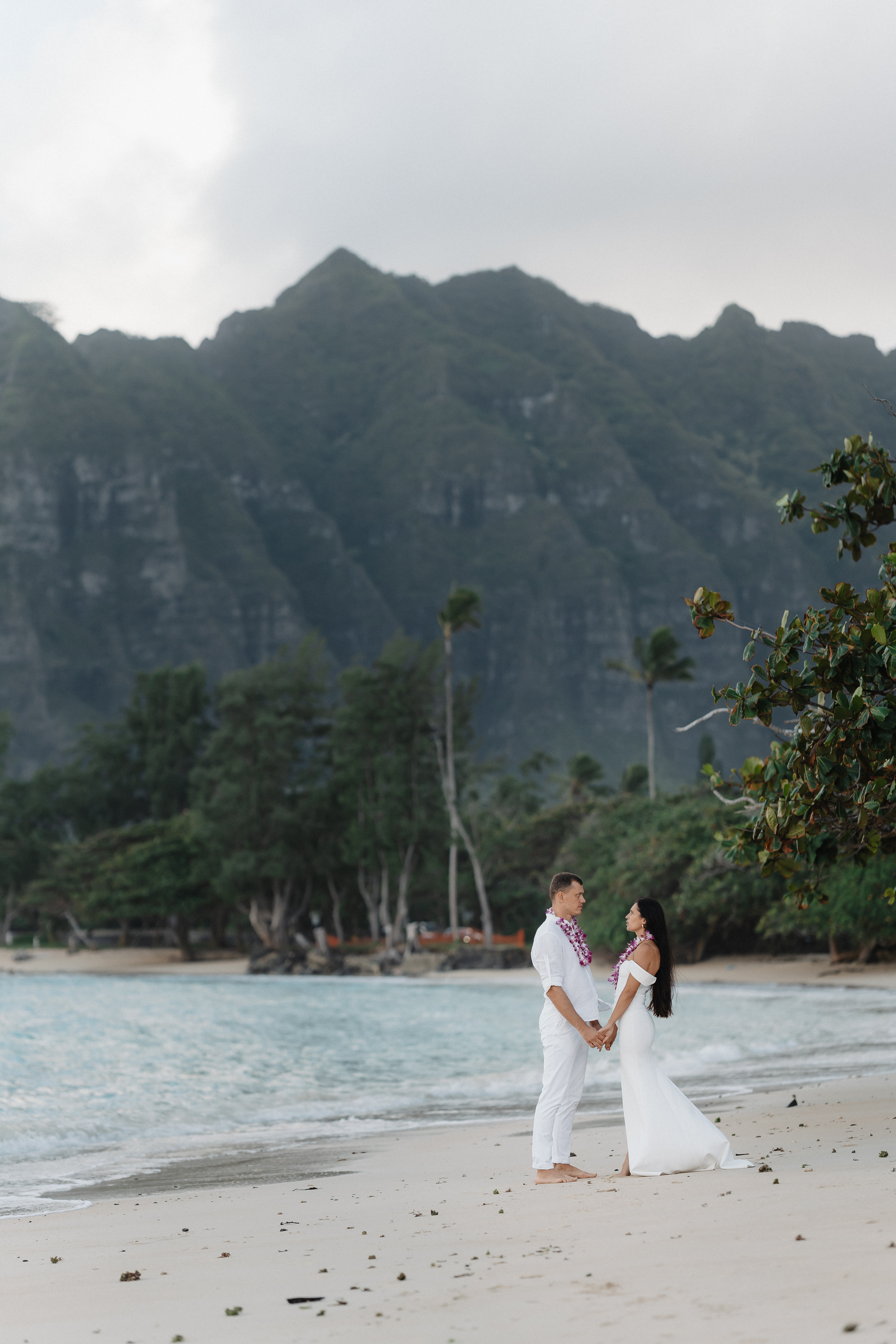Couple on beach with Hawaiian mountains in the background